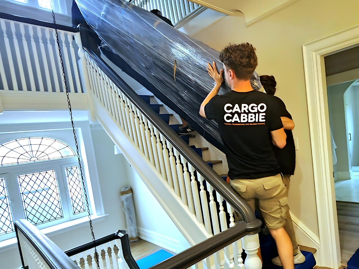 Professional movers carefully moving a home